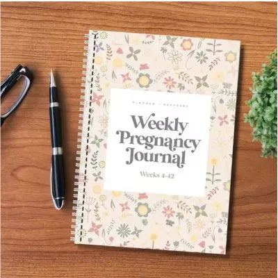 A5 size weekly pregnancy diary notebook open on a page showing weekly layout