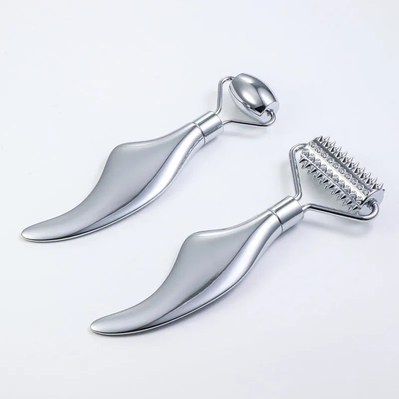 Stainless steel facial massage roller and heart-shaped gua sha scraping plate on a simple background.