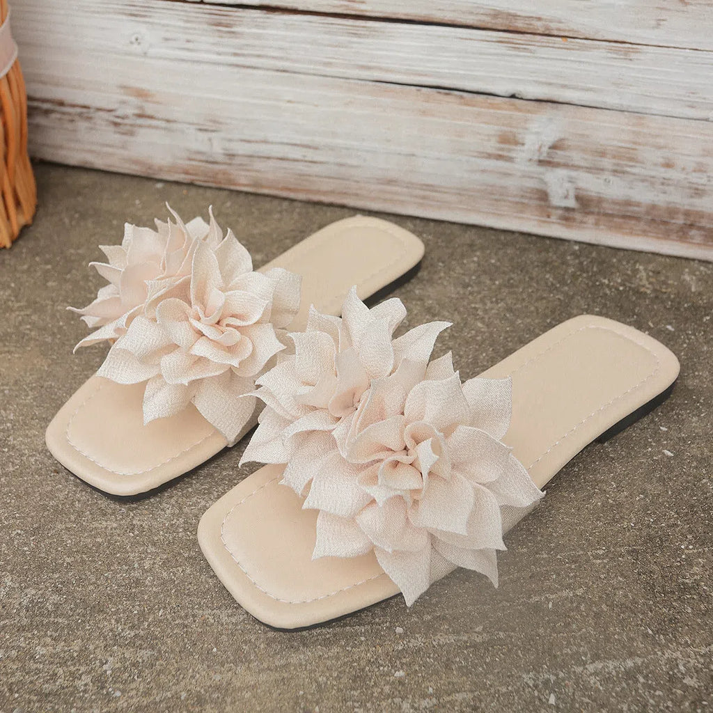 Women's flat flip-flops with flower detail, PU upper, rubber sole, apricot colour, on plain background