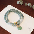 Close-up of a women's Myanmar jade bracelet with a safety buckle pendant, crystal, and geometric lucky beads in a new Chinese style.