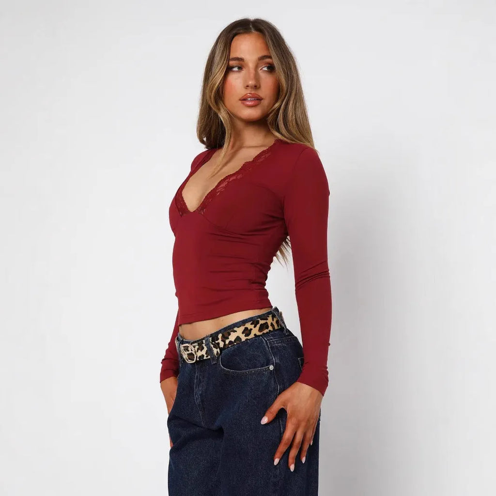Women's black slim-fit pullover top with lace floral detailing and long sleeves