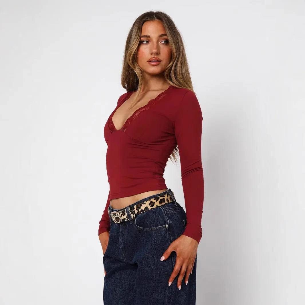 Women's black slim-fit pullover top with lace floral detailing and long sleeves