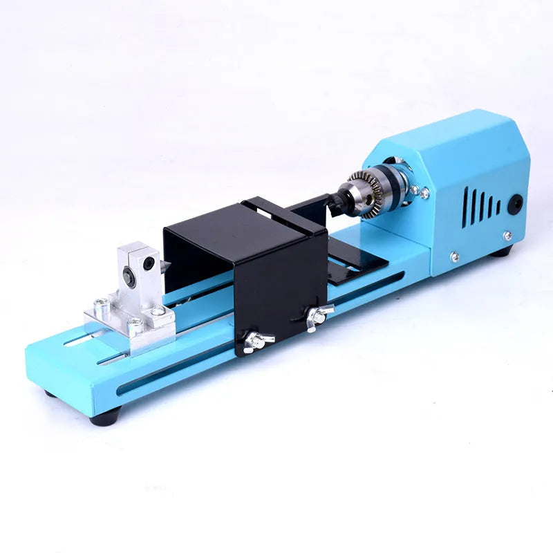 Mini DIY woodworking lathe in blue with protective cover, chuck, and accessories on a white background