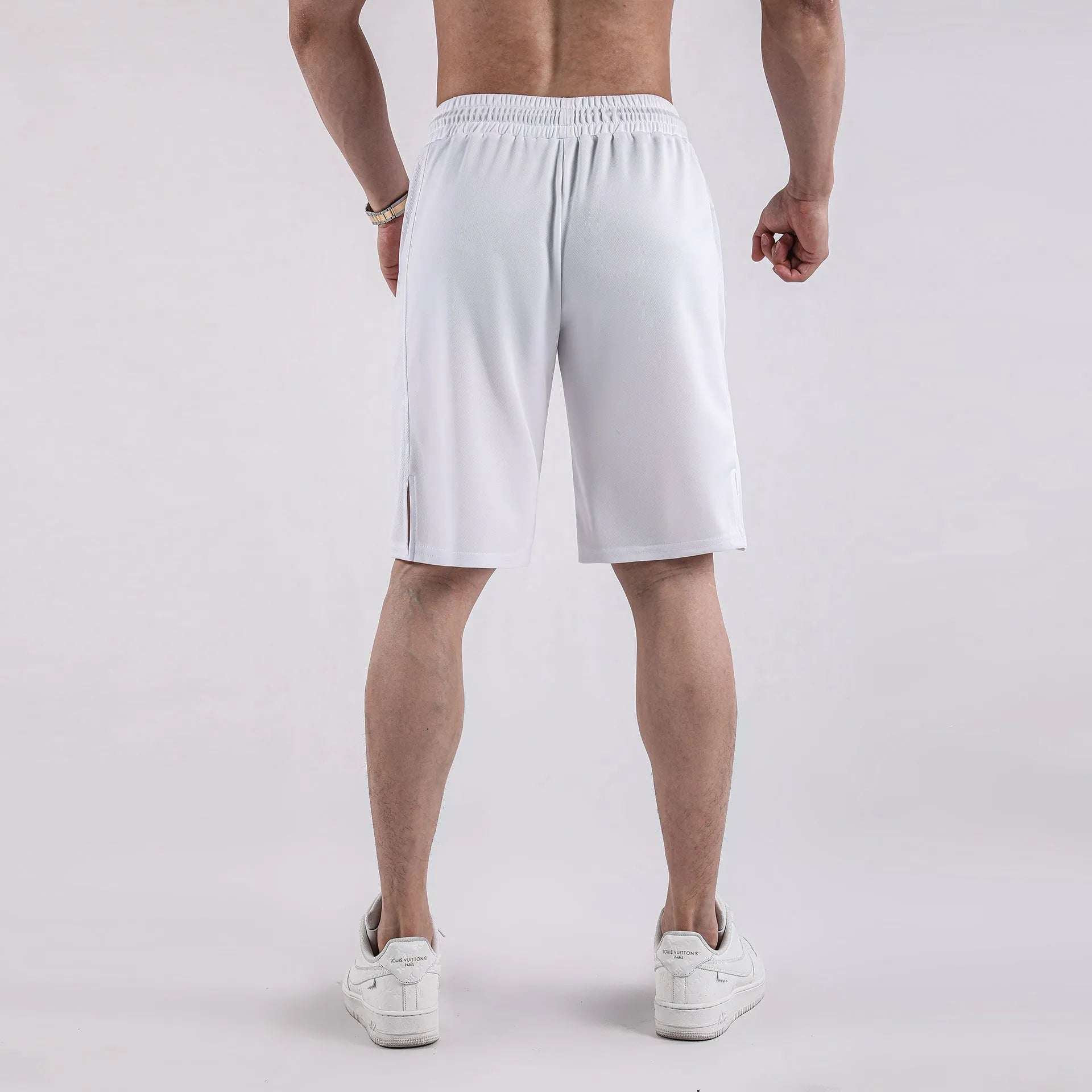 Man wearing black quick-dry mesh capri shorts with a loose, casual fit.
