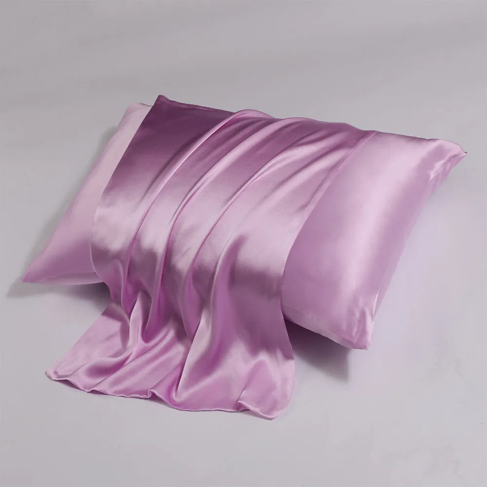 Close-up of a light champagne coloured mulberry silk pillowcase with a visible zipper closure along one edge.