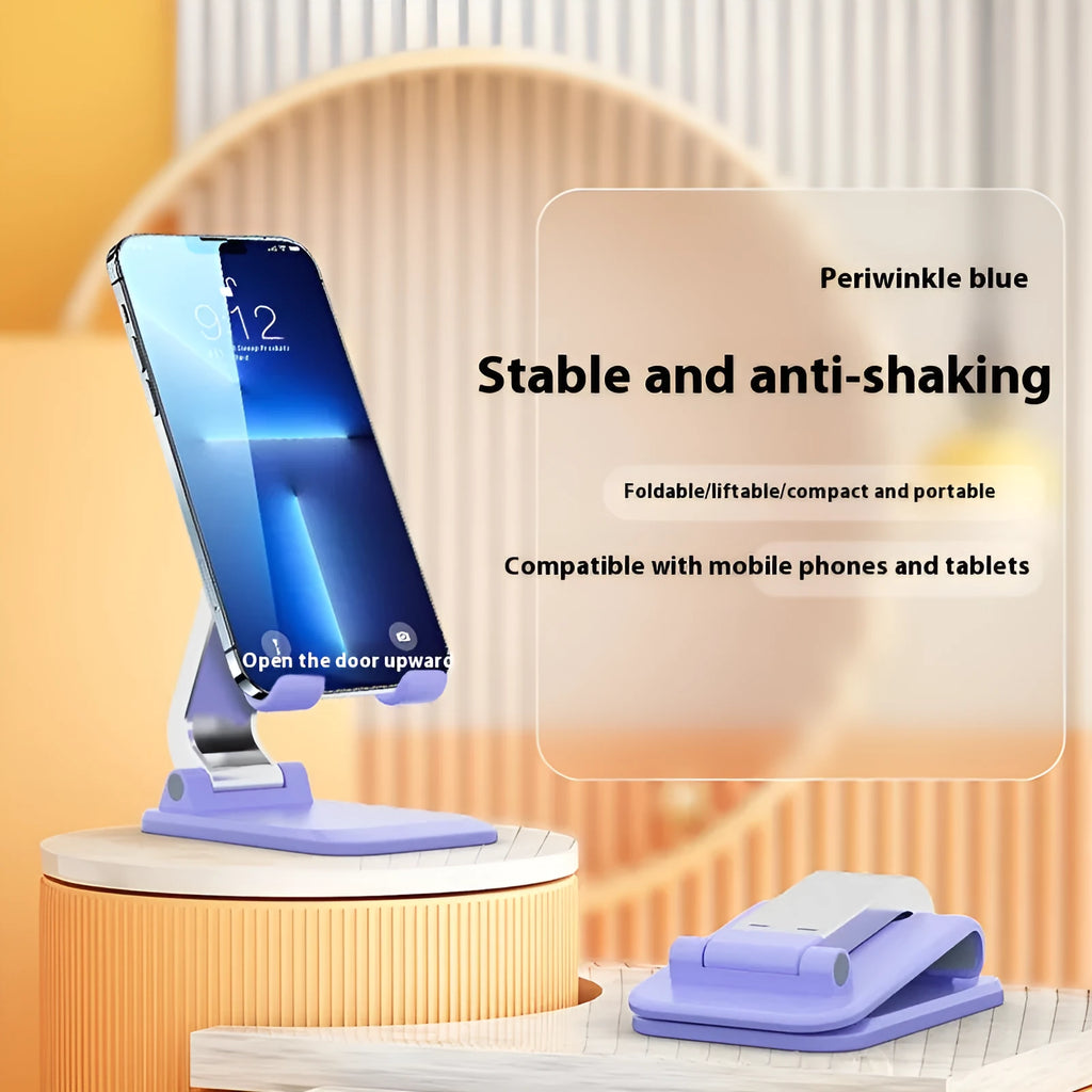 Foldable aluminium alloy phone holder in black on a wooden desk with a smartphone propped up for viewing