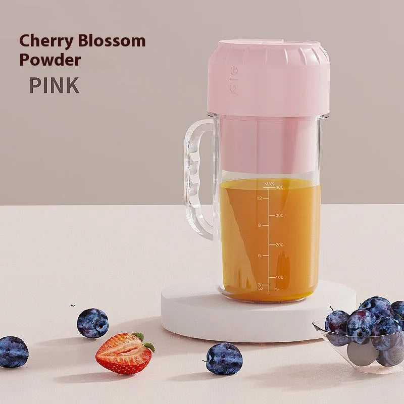 Portable USB charging personal juicer in cherry blossom pink or avocado green colour on a table.