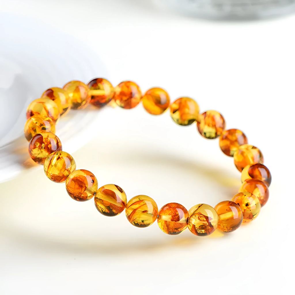 Natural yellow piebald amber bracelet with flower spot patterning and geometric design