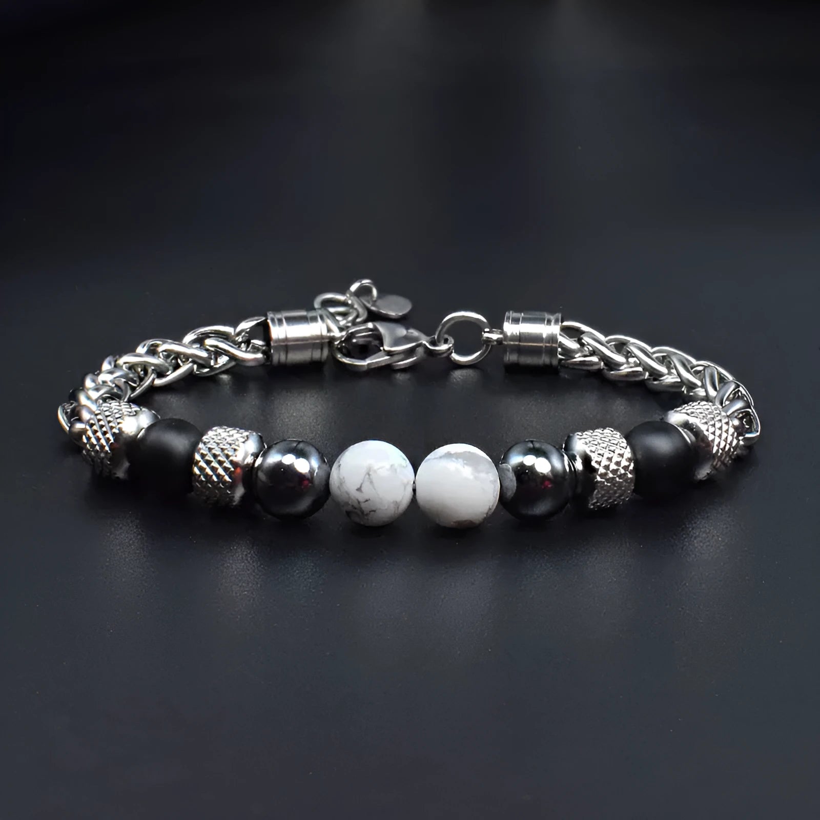 Titanium steel polished bracelet with yellow tiger eye beads and iron accents on white background
