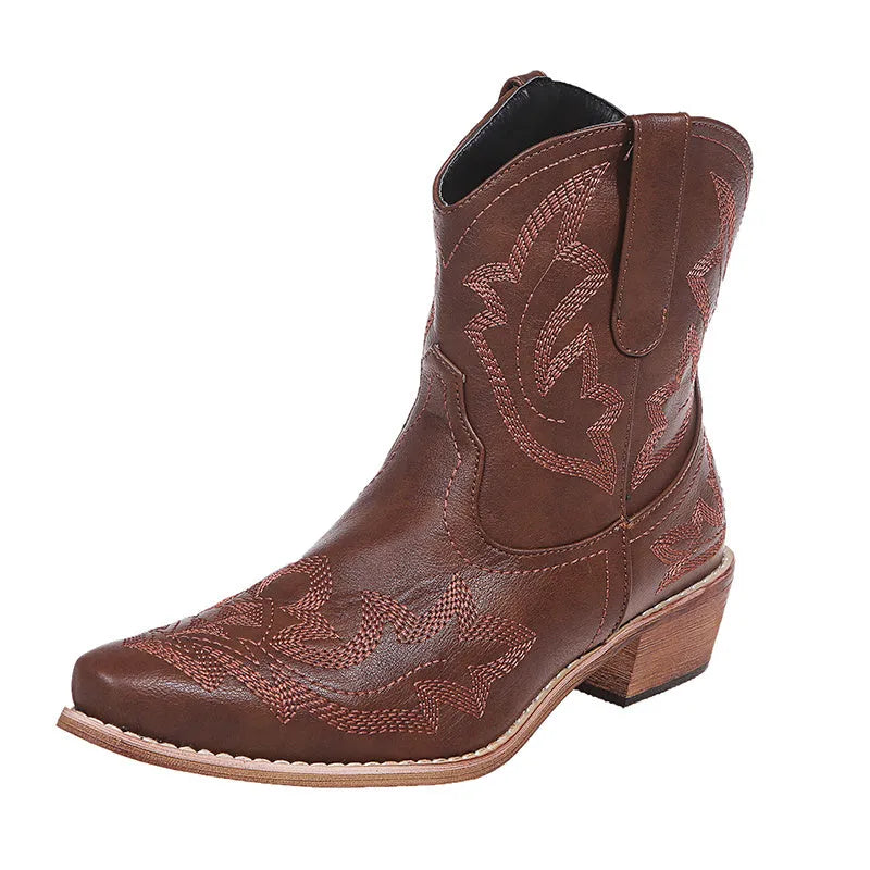 Women's blue embroidered cowboy boots with a wedge heel and pointed toe on a white background.