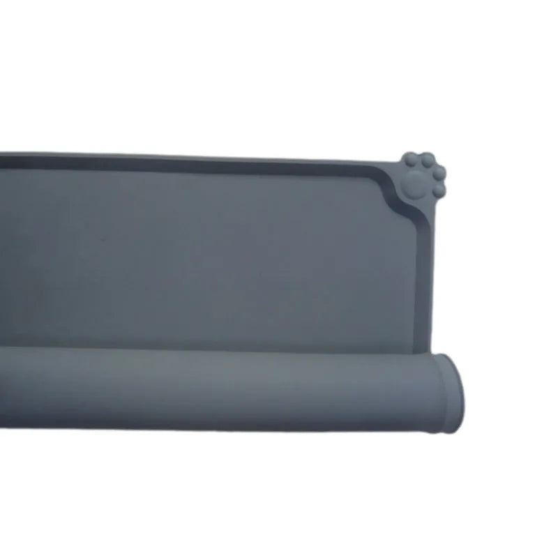 Grey waterproof silicone pet mat with raised edges and a non-slip base, measuring 47x29.5cm, placed under two pet bowls