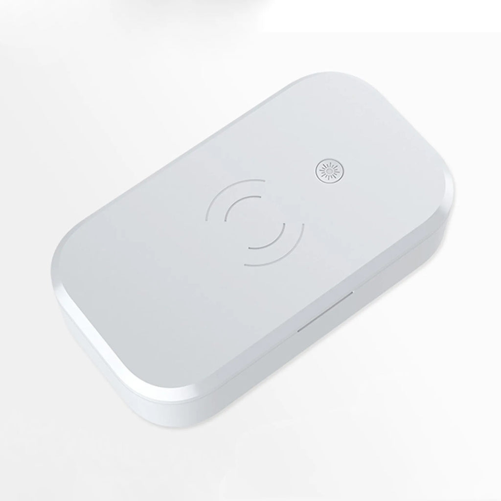 White UV disinfection box with wireless charging pad for mobile phones on top.