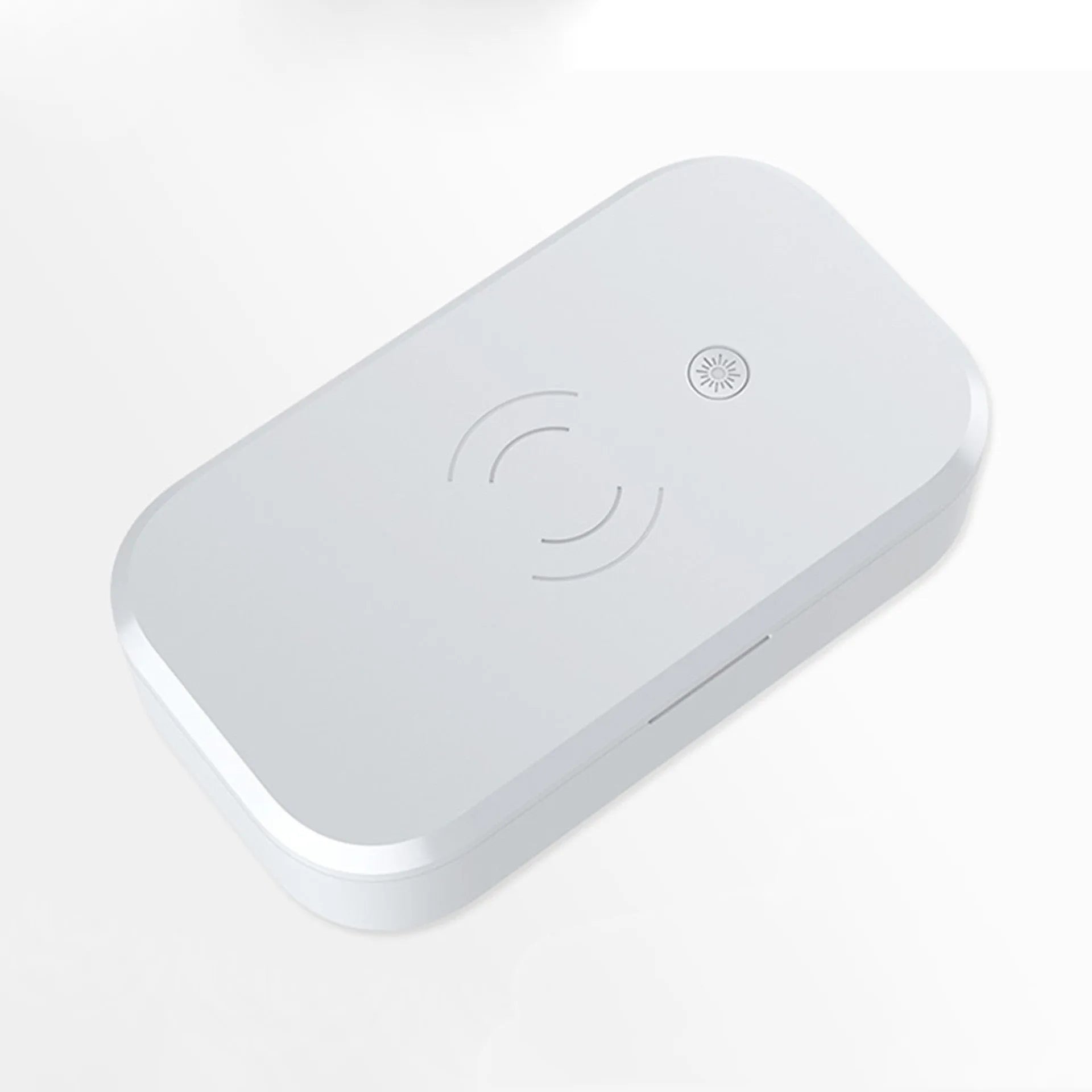 White UV disinfection box with wireless charging pad for mobile phones on top.