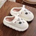 Pair of pink winter cartoon cat fluffy slippers on floor, non-slip EVA sole