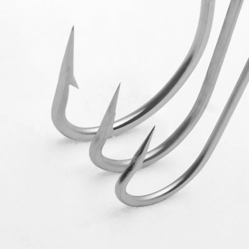 Assortment of alloy sea fishing hooks on a blue background for ocean boat fishing.