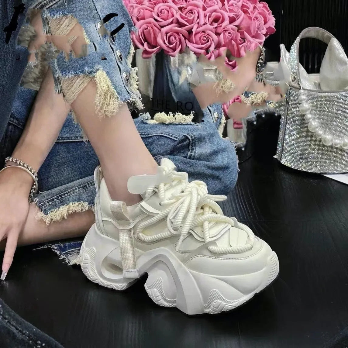 Women's creamy white wedge sneakers with cross straps and a lace-up front on a waterproof platform sole.