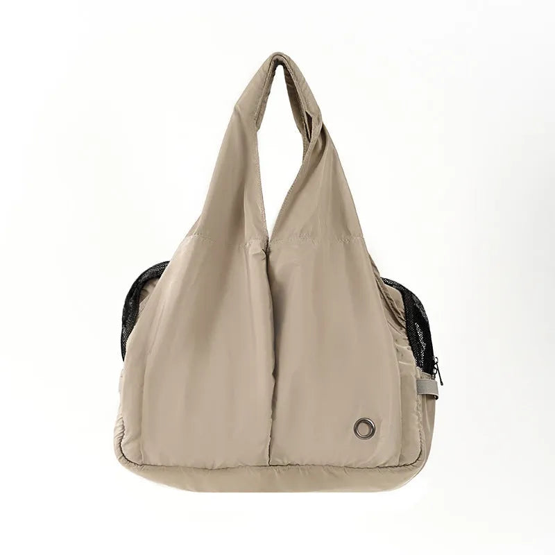 Apricot coloured cloth pet handbag carrier for cats or small dogs.