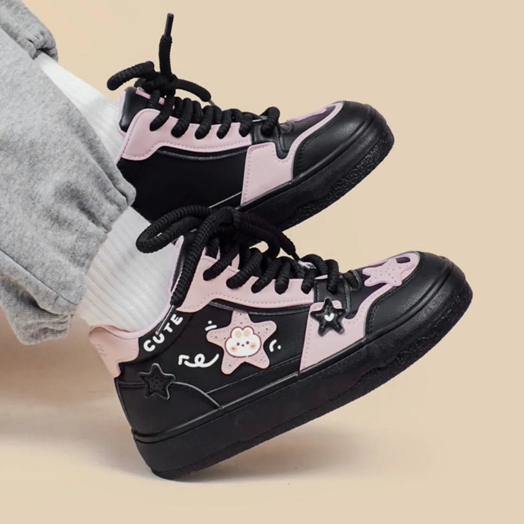 Women's black high top sneakers with cartoon anime pattern, colour blocking, cross straps, and lace-up closure