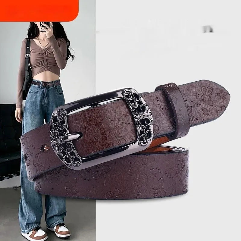 Thin black decorative jeans belt for women with an alloy buckle on a jeans waistband.