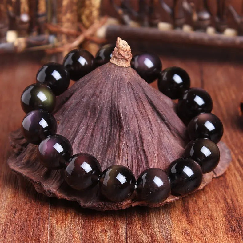 Polished crystal Pi Xiu bracelet with geometric ethnic design on a wrist, showing double eye ice stone pattern.