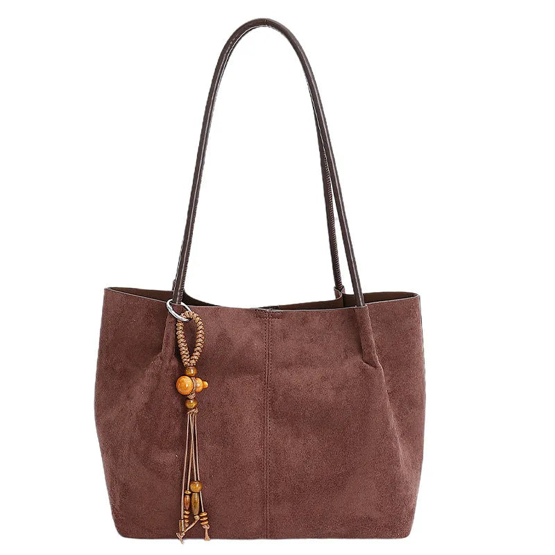 Large suede tote bag in brown with matching pendant, horizontal square shape, single shoulder strap, and retro styling