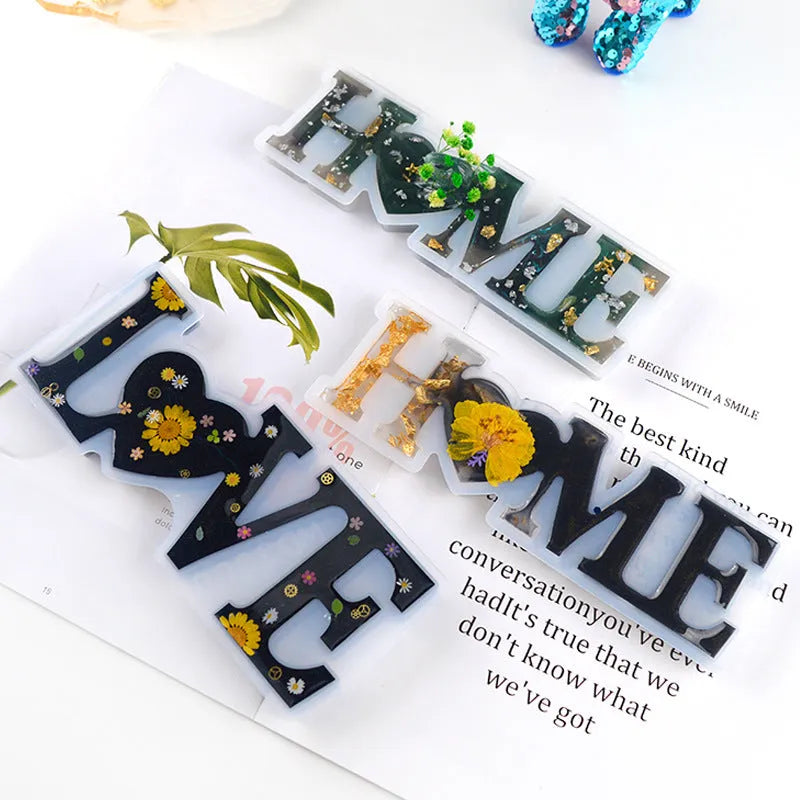 Silicone epoxy letter mold showing raised English alphabet and word impressions for resin jewellery making