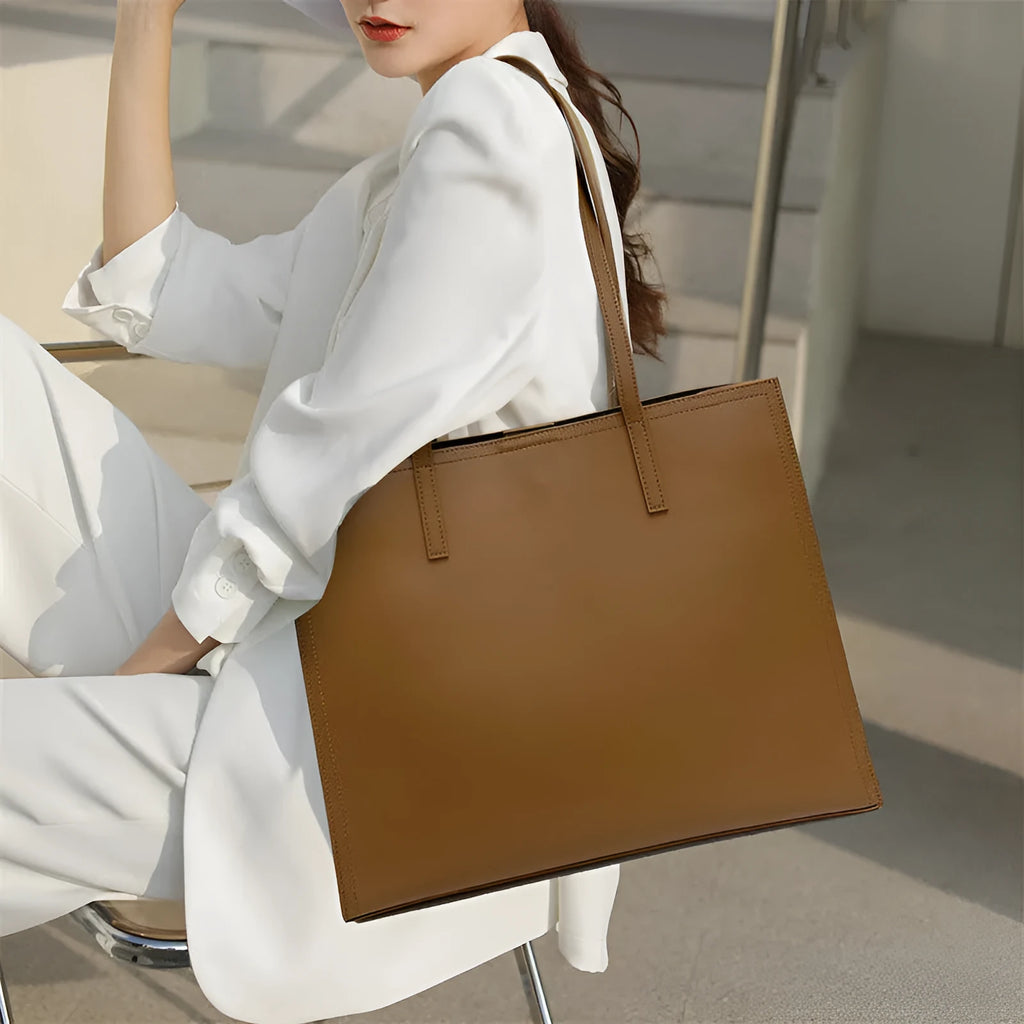 Women's brown genuine leather one shoulder handbag with horizontal square shape showing interior organisation compartments
