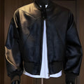 Men's black PU leather motorcycle-style jacket with an extended length and tight fit on a hanger.
