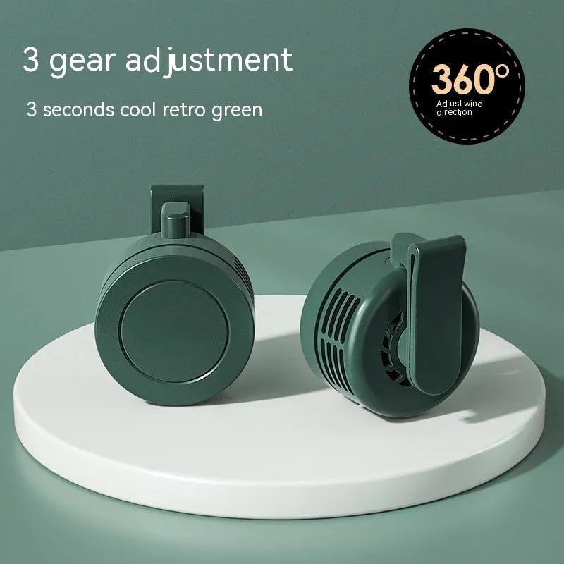 Green wrist-mounted fan with LED light and USB charging port showing three-speed controls