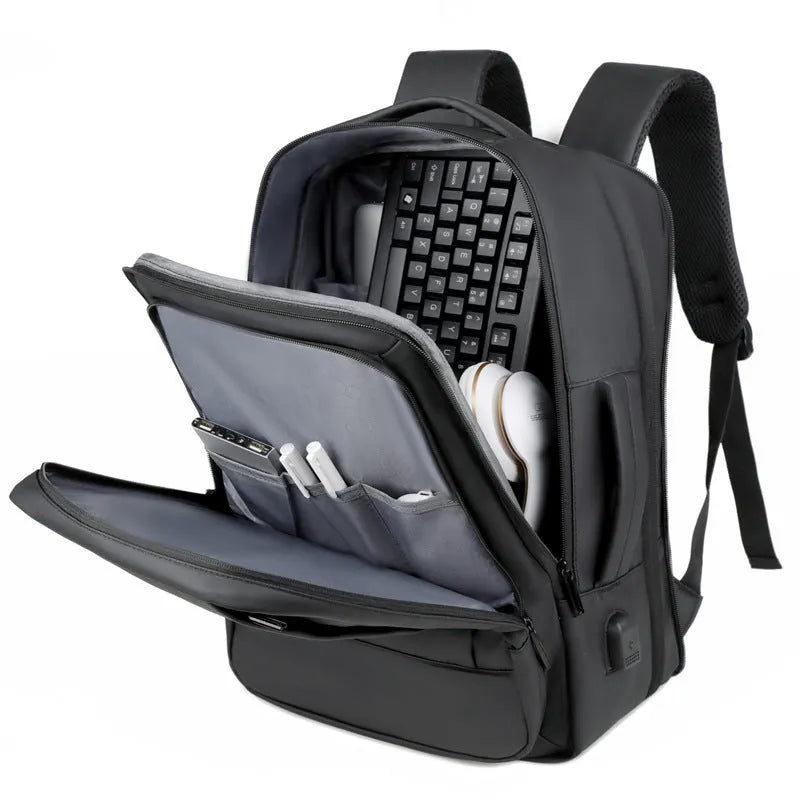 Black or grey large waterproof oxford cloth backpack with curved shoulder straps.