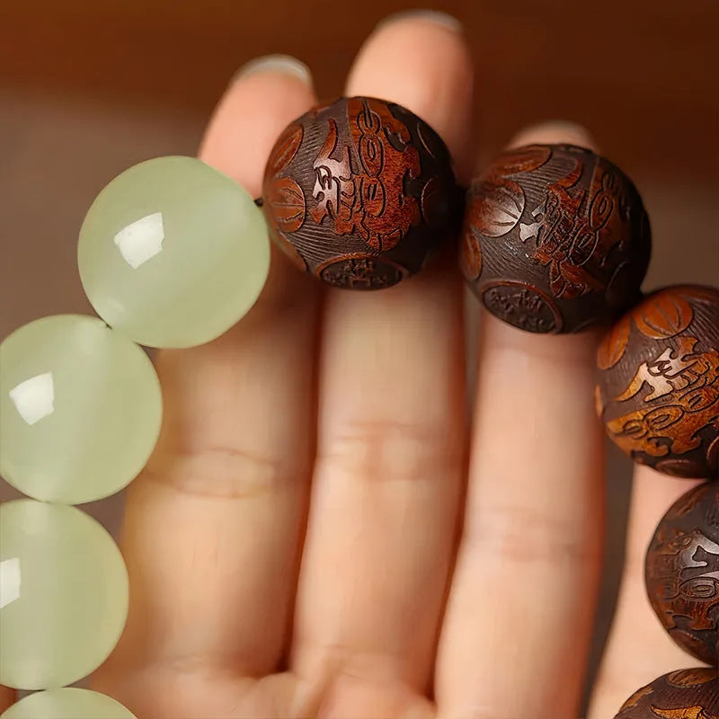 Rosewood bracelet with carved Fu character and amass fortunes design showing 12 wooden beads