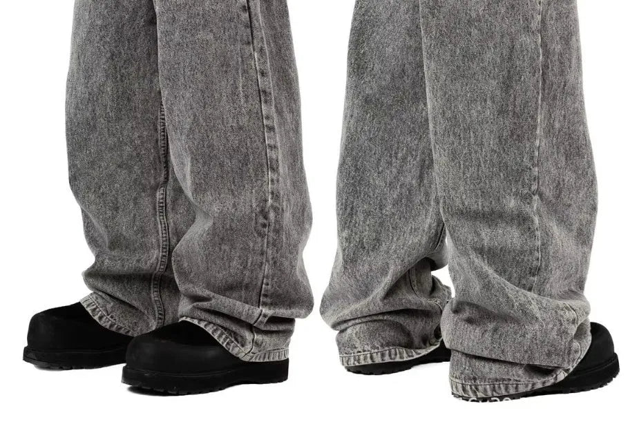 Grey loose fit straight-leg denim trousers on a mid-waist hanger
