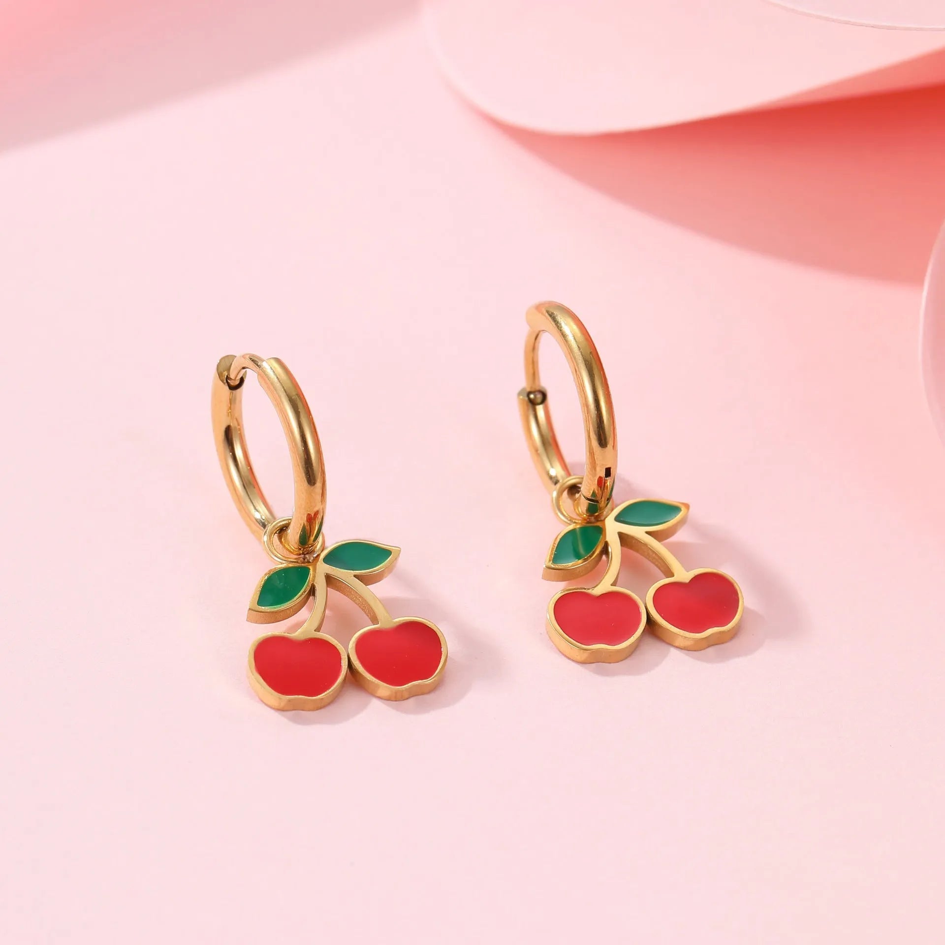 Complete cherry jewellery set showing stainless steel necklace, bracelet, earrings, and ring with 18K electroplating