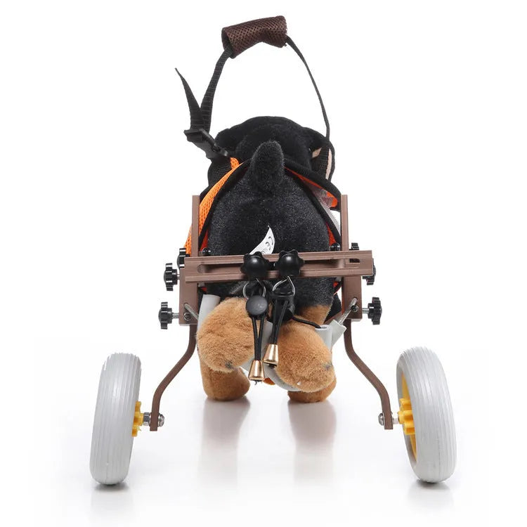 Grey dog wheelchair with adjustable frame, two wheels, and carrying handle on a light background