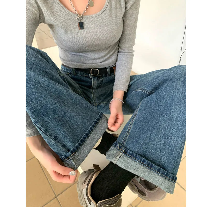Woman wearing retro blue high-waisted straight-leg jeans in a cotton denim fabric.