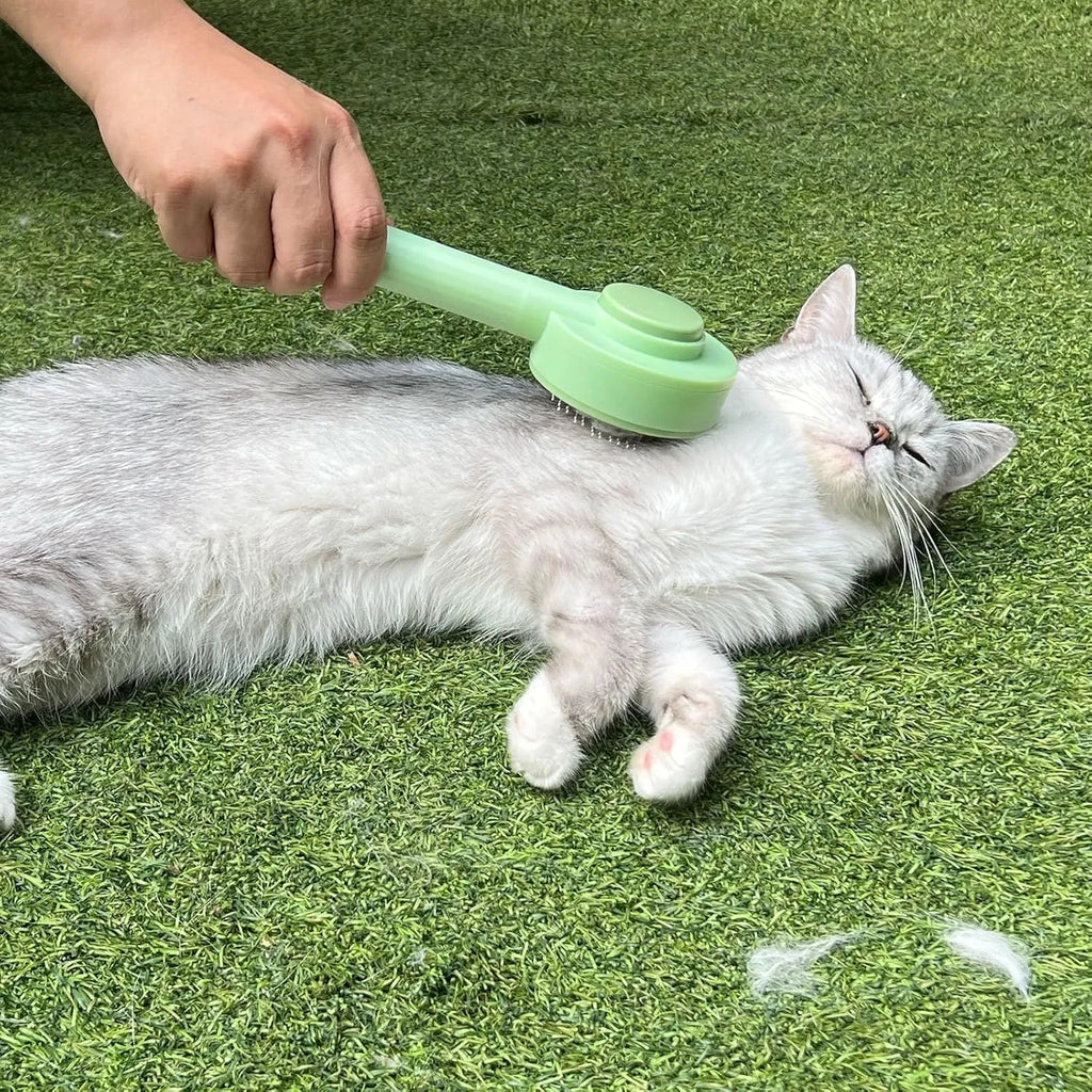 Green and yellow 2-in-1 cat grooming brush with stainless steel deshedding tool and hanging loop