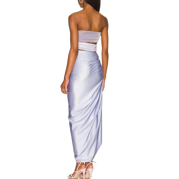 Purple women's one-piece swimsuit with a matching wrap skirt on a model, showing the quick-dry fabric and tight fit.