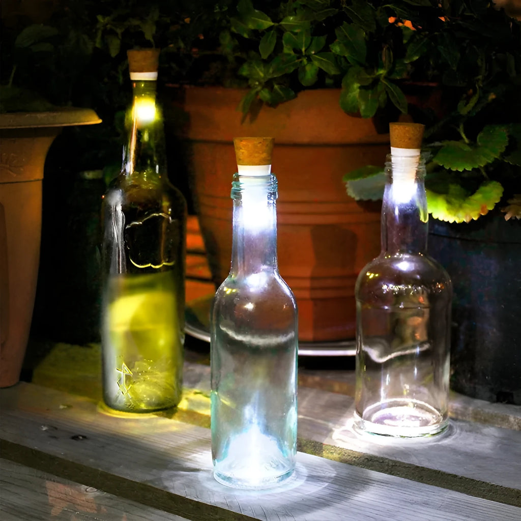 White plastic rechargeable LED bottle cap light with 15 beads, shown on a wine bottle for holiday decor.