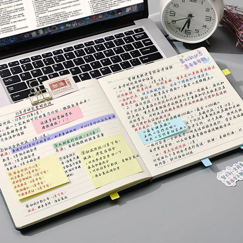 Square faux leather notebook open on a table, showing Daolin paper and French fold binding.
