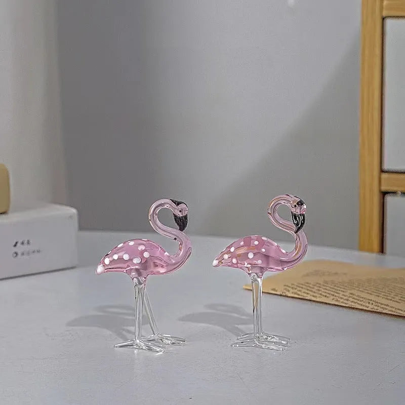 Pink and white crystal flamingo decorative ornament on a table.