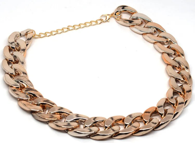 A gold chain-link style dog collar ornament on a white background.