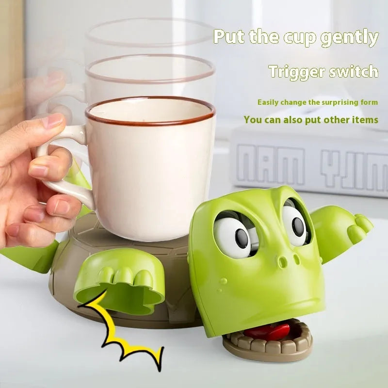 ABS plastic turtle coaster in green shape on desk with a glass of water nearby