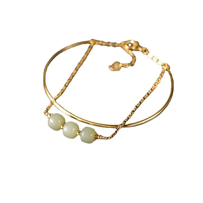 Women's Hetian jade bracelet with gold inlay design in single, double, or three-bead versions.
