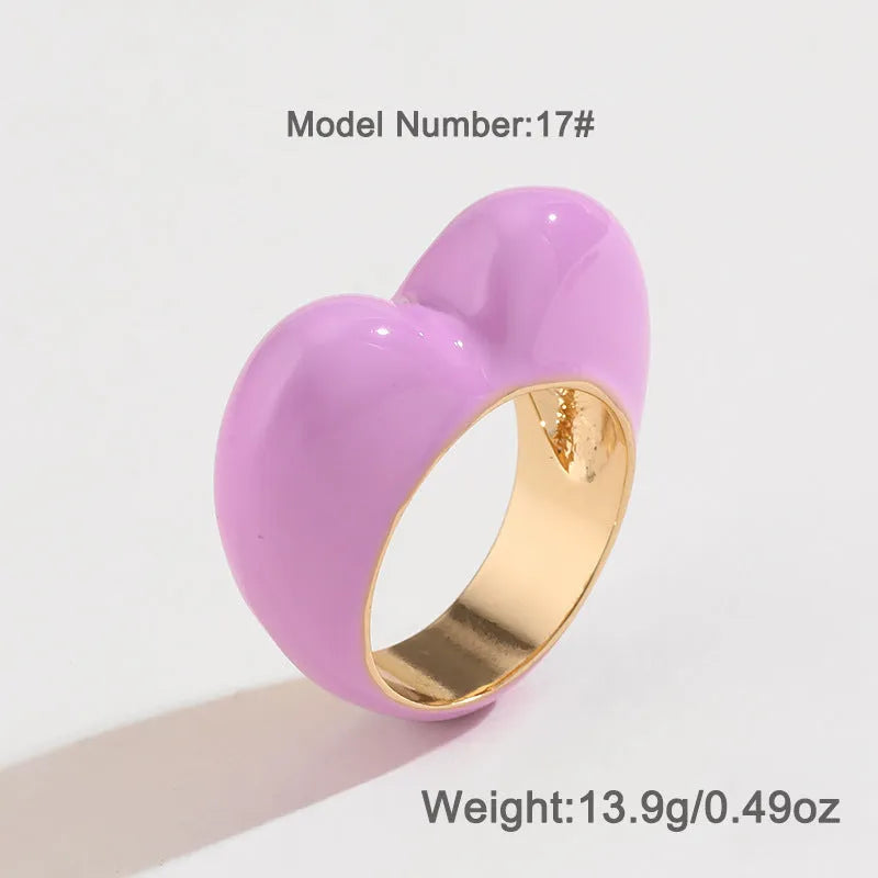 Colourful three-dimensional heart-shaped enamel ring made from zinc alloy, shown in red.