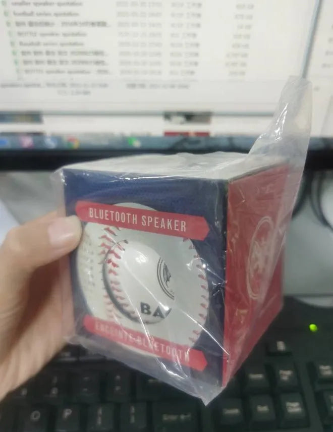 Baseball-shaped Bluetooth speaker in green colour with USB charging port