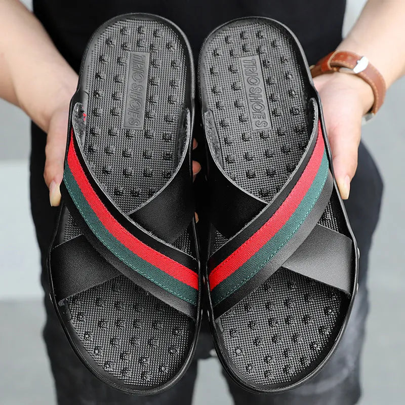 Men's white cowhide leather flip-flops with a non-slip PU sole on a sandy beach.