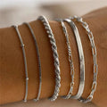 Multi-layer chain minimalist bracelet in zinc alloy with electroplated finish, geometric shape, unisex design, four colour options.
