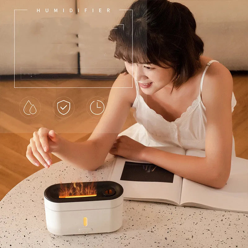 White resin flame lamp humidifier with two fog outlets and visible flame effect on a wooden table