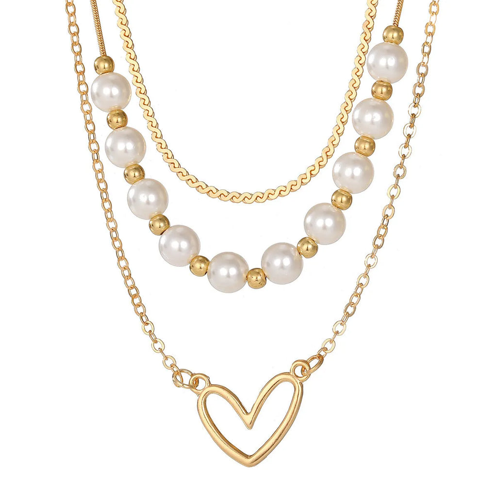 Gold tone heart-shaped pendant necklace with pearl chain, vintage love symbol jewellery
