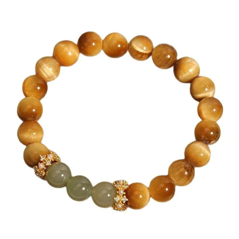 Natural yellow tiger's eye stone bracelet with gold gourd pattern on a white background.